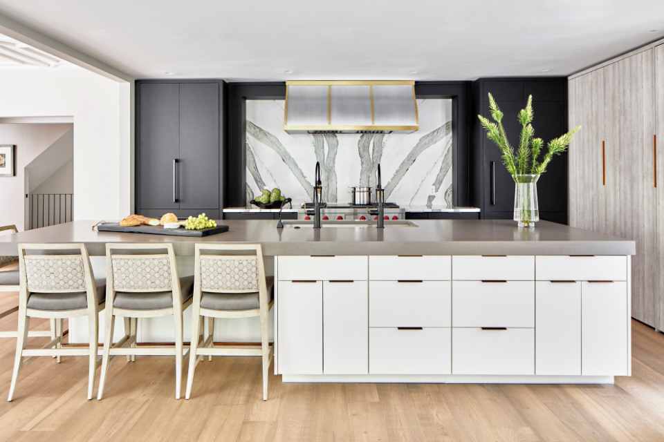 designer kitchen in modern home with custom marble backsplash behind stove